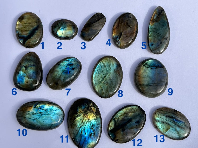 Labradorite Oval Cabochons with varing Blue, orange, yellow and purple flash.