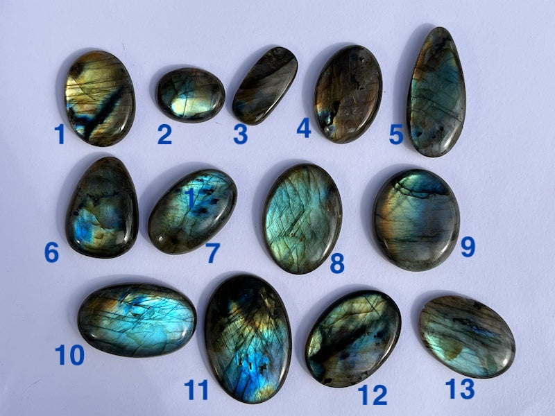 Labradorite Oval Cabochons with varing Blue, orange, yellow and purple flash.