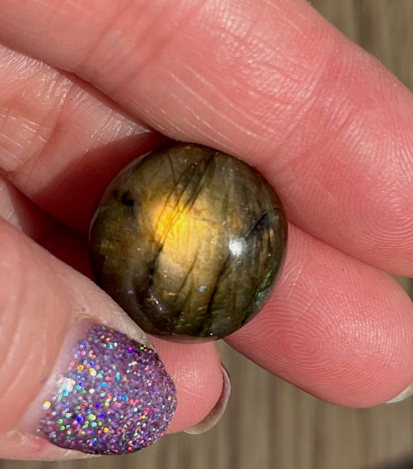 Labradorite Round Cabochons with vering Blue, orange, yellow and purple flash.