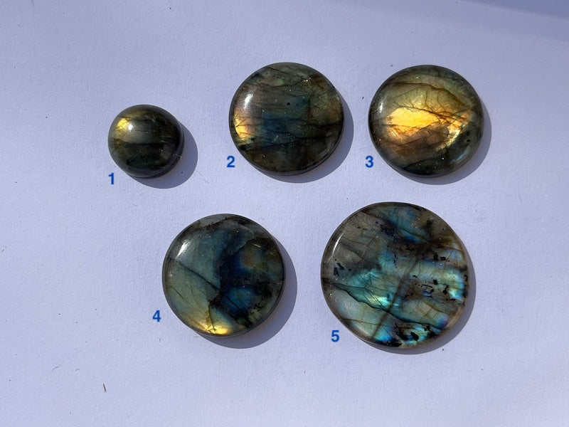 Labradorite Round Cabochons with vering Blue, orange, yellow and purple flash.