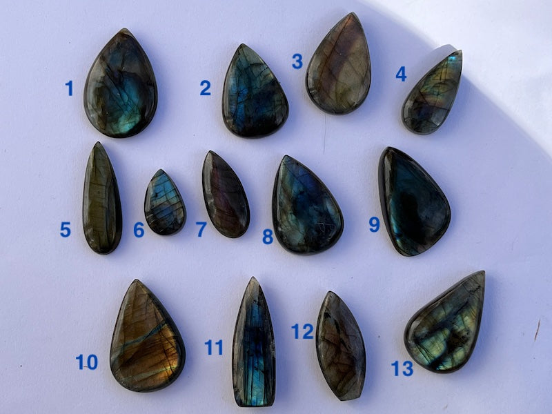 Labradorite Teardrop, Pear Cabochons with varing Blue, orange, yellow and purple flash.