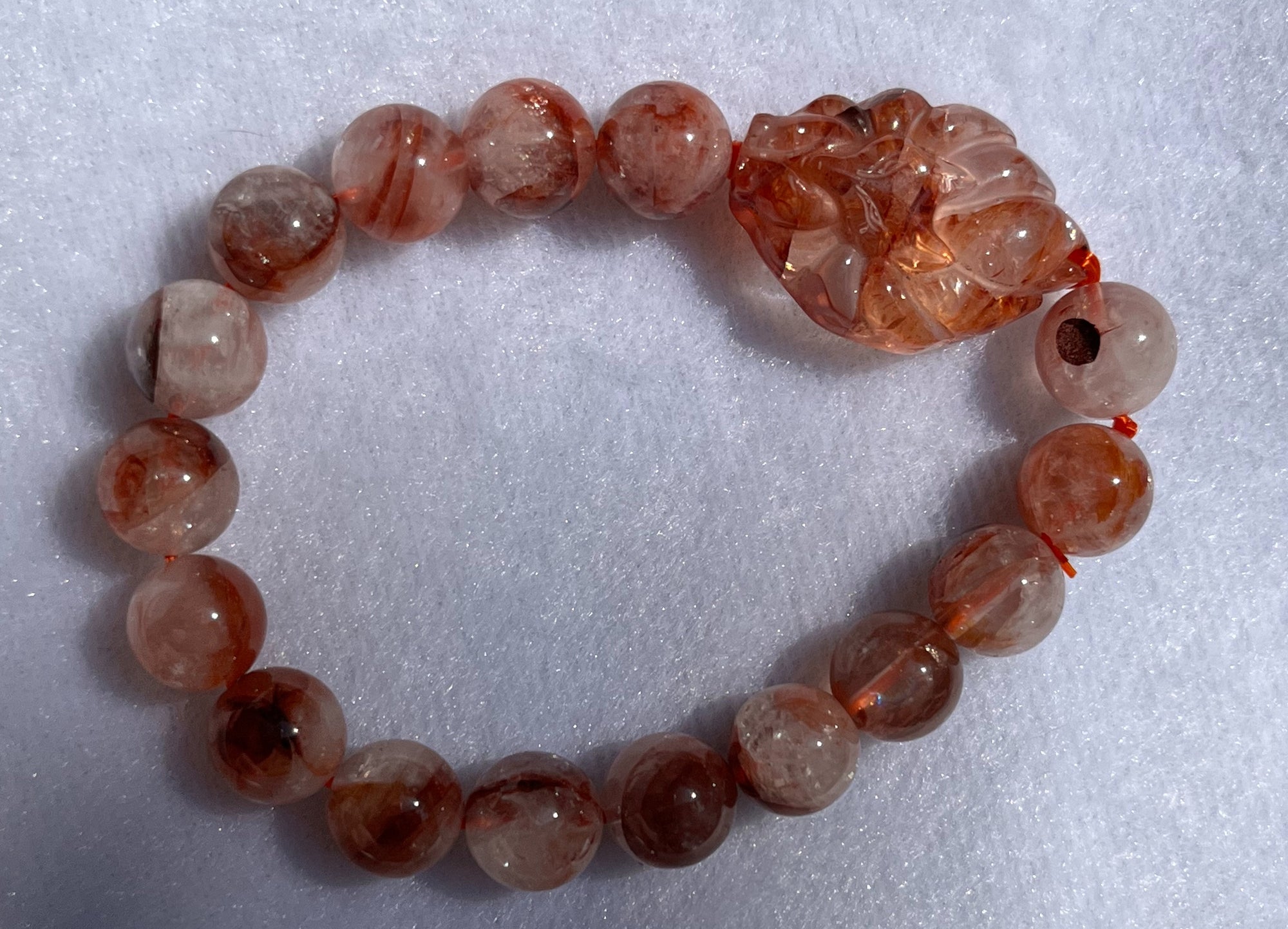 Bracelet, fire quartz round faceted beads with fire quartz 9 tail fox, 10mm beads