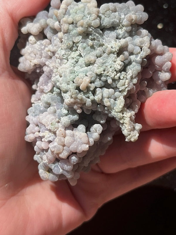 Green and turquoise run through the back of this grape agate cluster