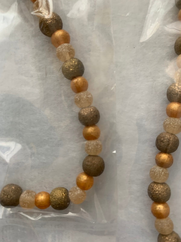 Bead, glass, 7" strand, amber and green colour