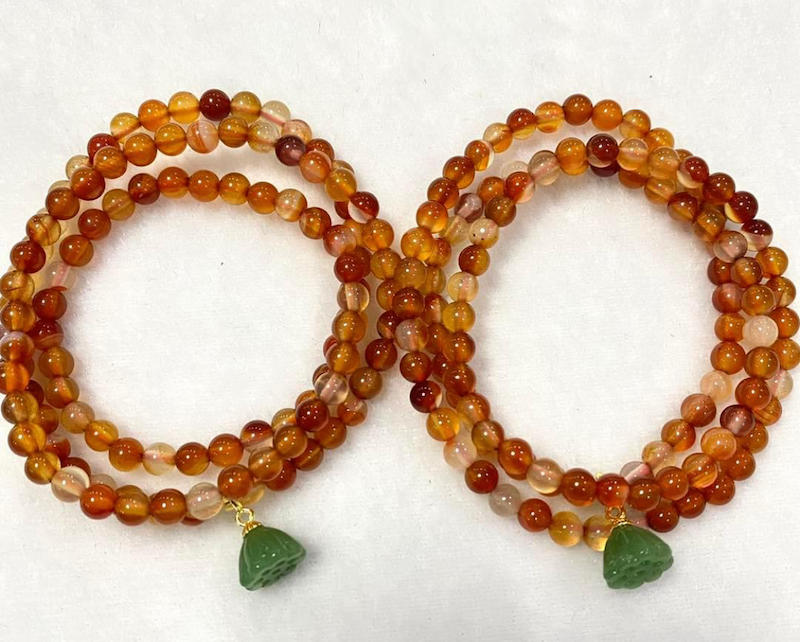 Bracelet, carnelian beads, 3 laps with jade lotus flower.